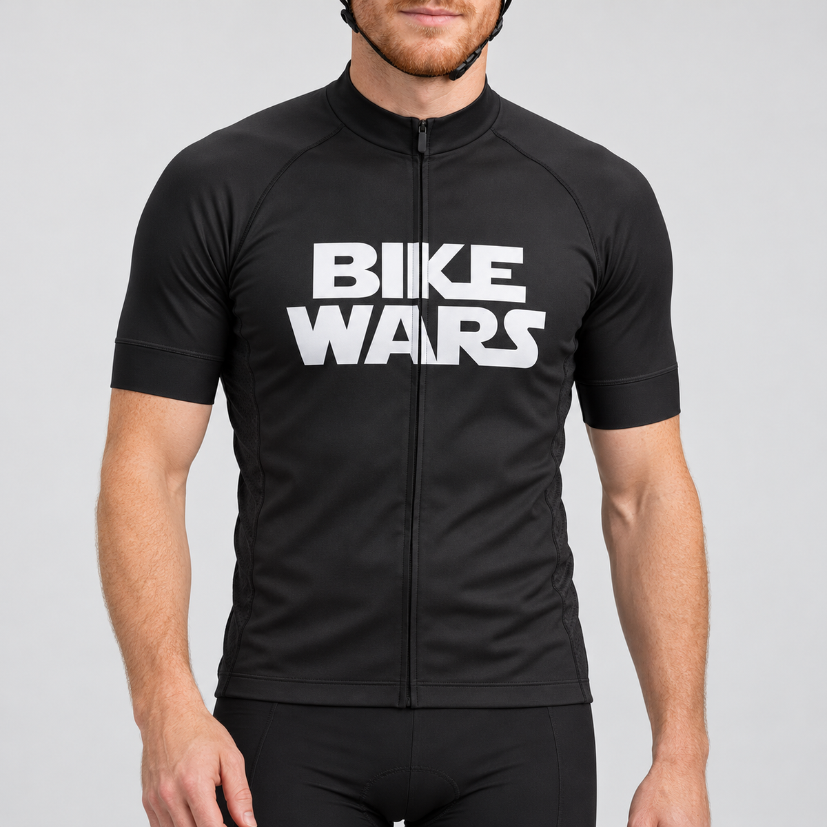 Male model wearing the black short-sleeve Bike Wars cycling jersey with white BIKE WARS lettering and black cycling shorts, shown from the lower lip down against a neutral studio background.