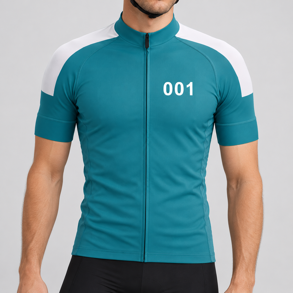Male model shown from the chin down wearing the teal Squid Character 001 short-sleeve cycling jersey with white shoulder panels and white 001 chest number against a light grey studio background.