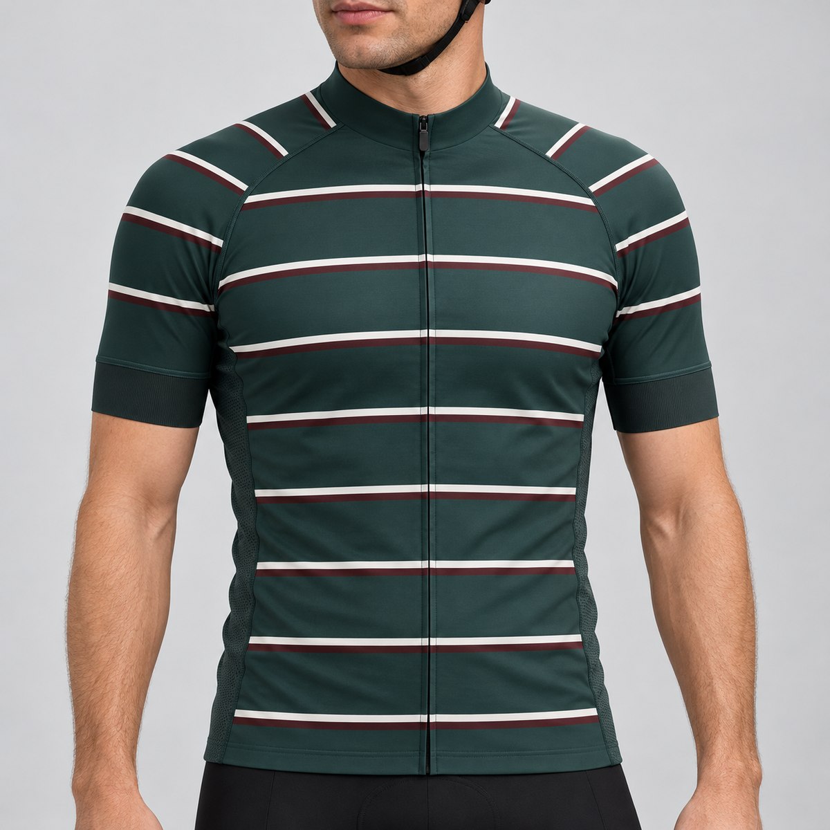 Male model wearing the dark green short-sleeve GG BASICS Green Hoops cycling jersey with cream and burgundy horizontal stripes, shown with black cycling shorts against a light grey studio background.