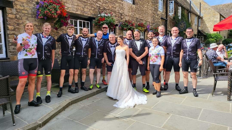 A wedding group wearing tuxedo and floral cycling jerseys