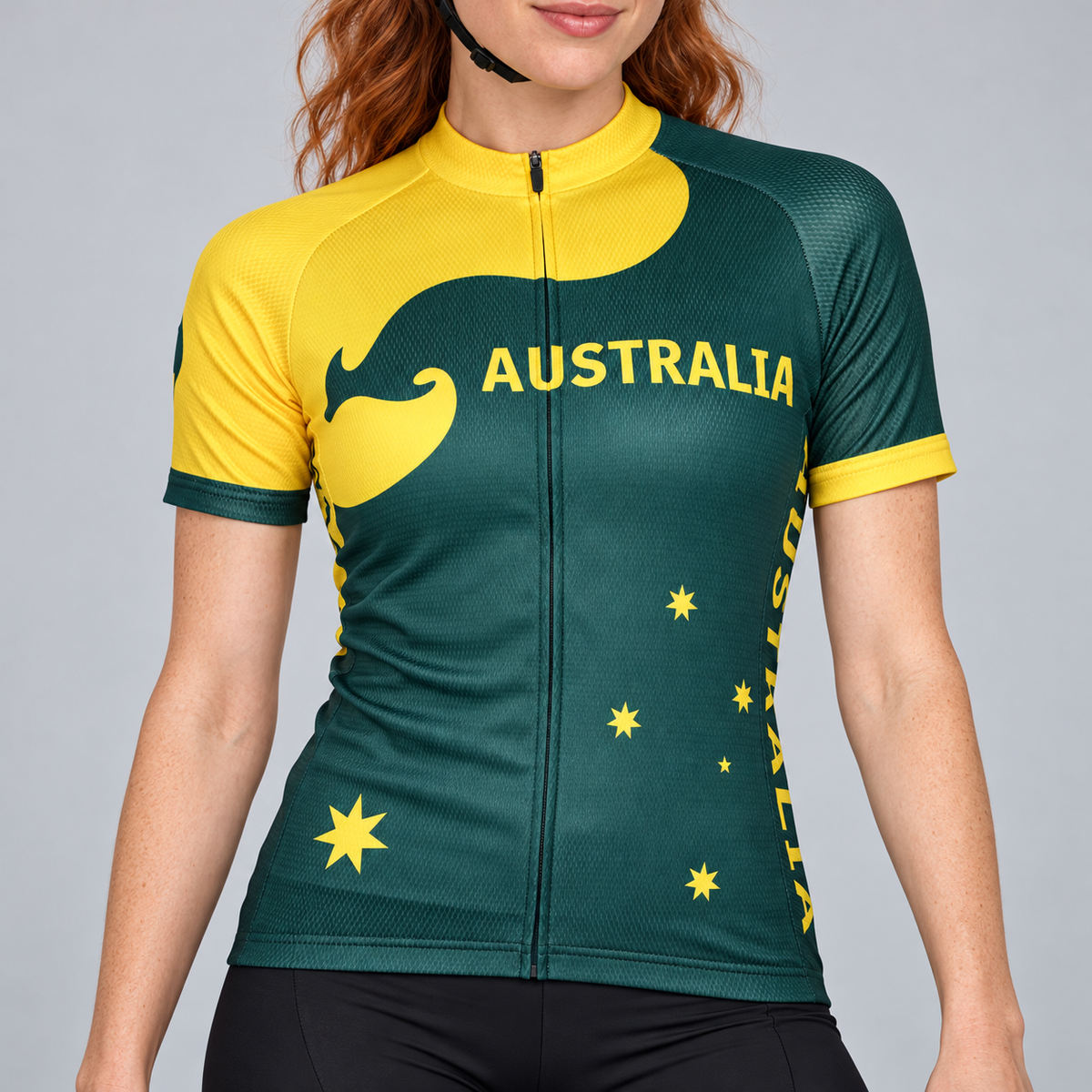 Female model wearing the green and yellow short-sleeve Australia cycling jersey with kangaroo and star graphics and black cycling shorts, shown from the lower lip down against a light grey studio background.