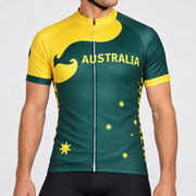 Male model wearing the green and yellow short-sleeve Australia cycling jersey with kangaroo and star graphics and black cycling shorts, shown from the chin down against a neutral studio background.