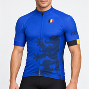 Male model wearing the blue short-sleeve Belgium cycling jersey with dark lion graphic, Belgian flag and black cycling shorts, shown from the lower lip down against a neutral studio background.