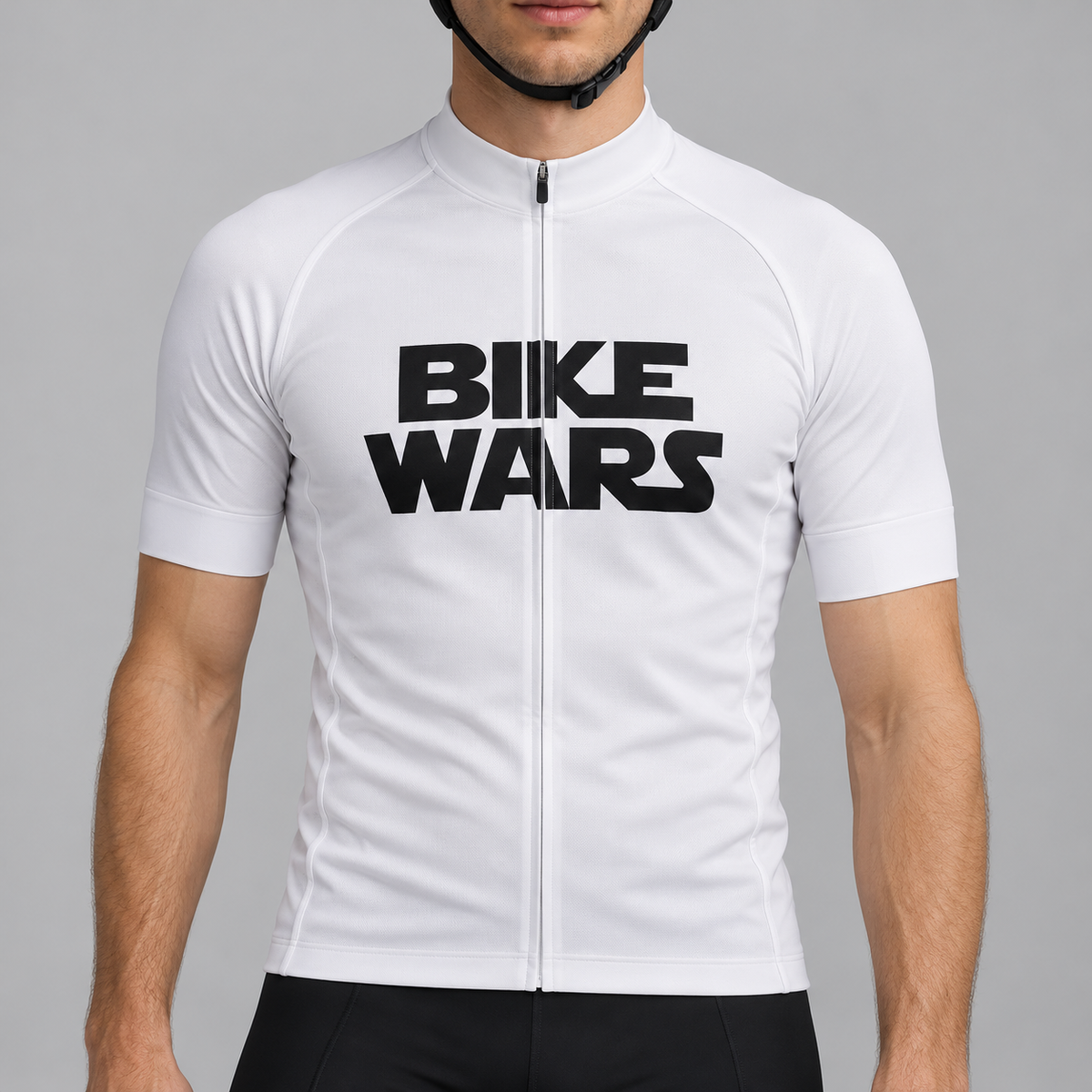 Male model wearing the white short-sleeve Bike Wars cycling jersey with black BIKE WARS lettering and black cycling shorts, shown from the lower lip down against a neutral studio background.