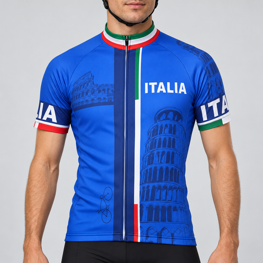 Male model wearing the royal blue short-sleeve Italia cycling jersey with Italian tricolour details, ITALIA lettering and landmark graphics, shown from the chin down with black cycling shorts against a neutral studio background.