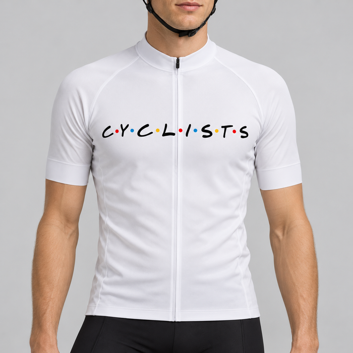 Male model wearing the white short-sleeve C.Y.C.L.I.S.T.S cycling jersey with black chest lettering and coloured dots, shown from the chin down with black cycling shorts against a neutral studio background.