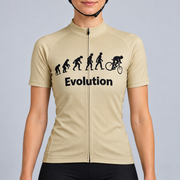 Female model wearing the beige short-sleeve Evolution Of Man cycling jersey with black evolution silhouettes, cyclist graphic and Evolution wording, shown with black cycling shorts against a light neutral studio background.