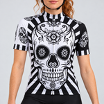 Female model wearing the black and white short-sleeve Flower Skull Print cycling jersey with floral skull graphics and striped trim, shown from the lower lip down with black cycling shorts against a light grey studio background.