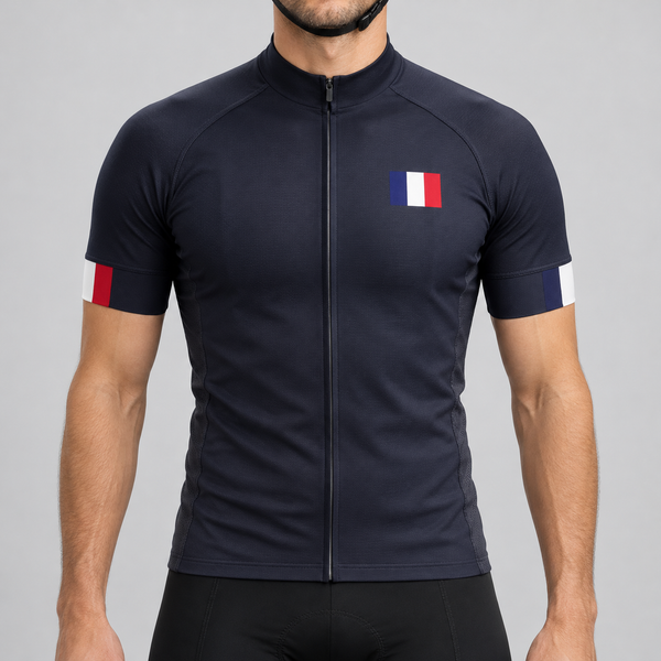 Male model wearing the dark navy short-sleeve France 2022 Football Inspired cycling jersey with French tricolour chest and cuff details, shown from the chin down with black cycling shorts against a neutral studio background.