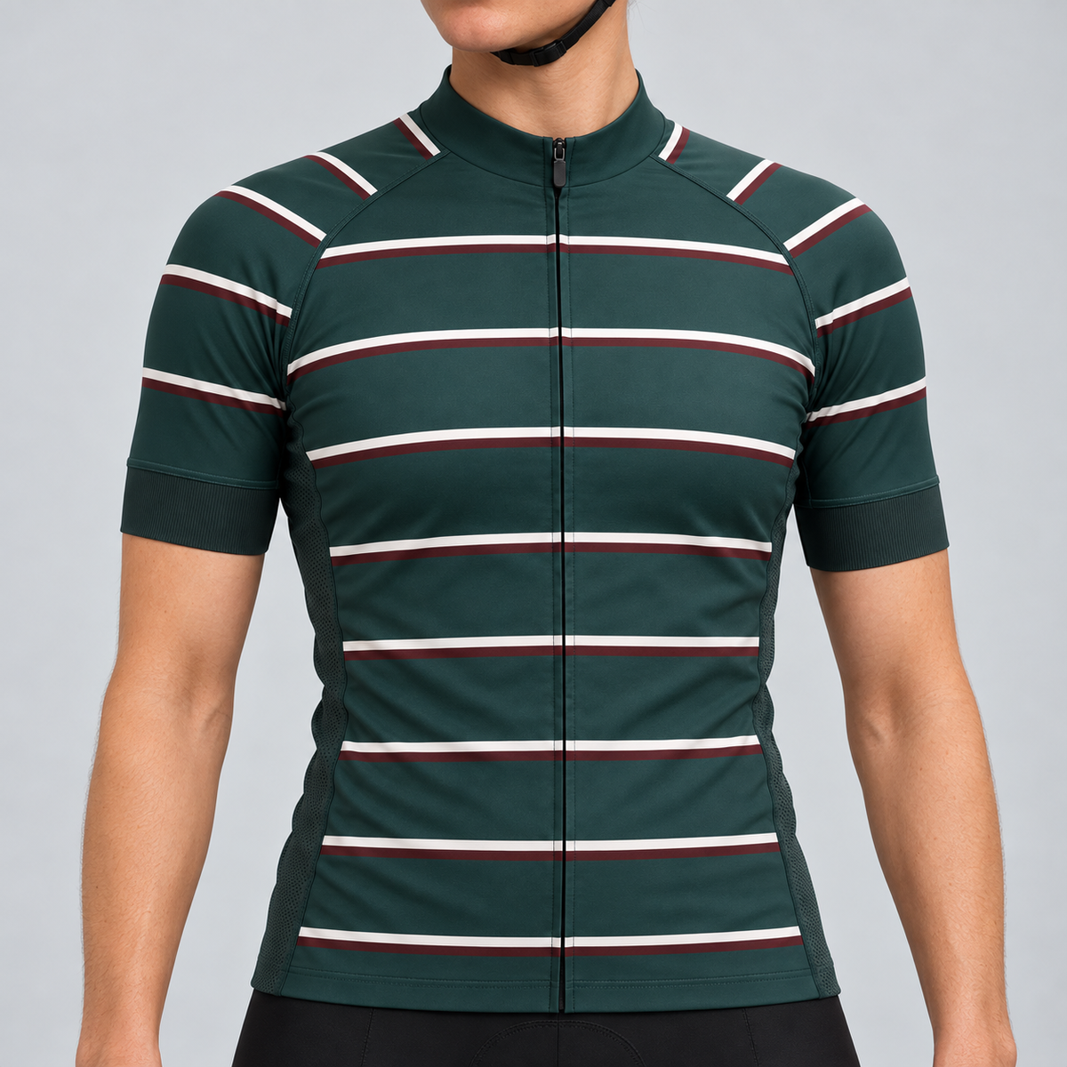 Female model wearing the dark green short-sleeve GG BASICS Green Hoops cycling jersey with cream and burgundy horizontal stripes, shown with black cycling shorts against a light grey studio background.