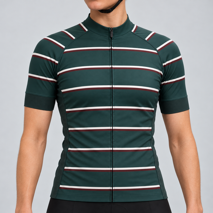 Female model wearing the dark green short-sleeve GG BASICS Green Hoops cycling jersey with cream and burgundy horizontal stripes, shown with black cycling shorts against a light grey studio background.
