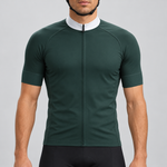 Male model wearing the dark green short-sleeve GG BASICS cycling jersey with a white collar, matching green cuffs and mesh side panels, shown with black cycling shorts against a light grey studio background.