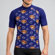 Male model wearing the navy Dog and Hearts Pattern short-sleeve cycling jersey with brown dog faces and white heart motifs, shown from the chin down with black cycling shorts against a neutral studio background.