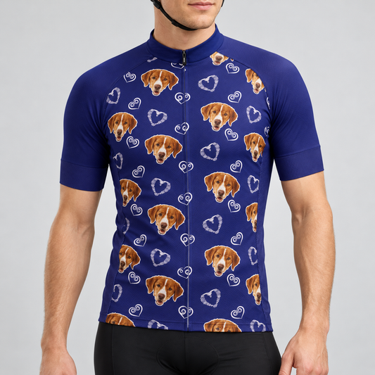 Male model wearing the navy Dog and Hearts Pattern short-sleeve cycling jersey with brown dog faces and white heart motifs, shown from the chin down with black cycling shorts against a neutral studio background.