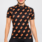 Female model wearing the black short-sleeve Hot Diggidy Dog cycling jersey with repeating hot dog graphics and black cycling shorts against a light grey studio background.