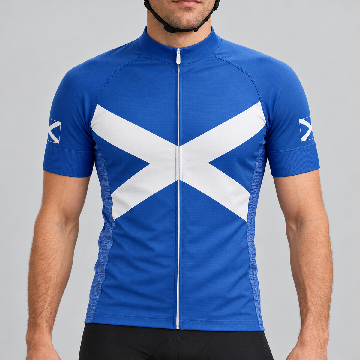 Male model shown from the chin down wearing the royal-blue Scotland Saltire short-sleeve cycling jersey against a light grey studio background.