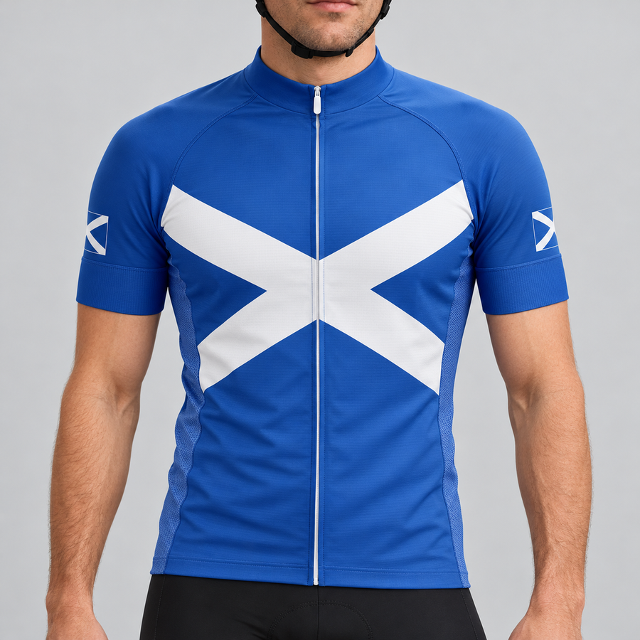 Male model shown from the chin down wearing the royal-blue Scotland Saltire short-sleeve cycling jersey against a light grey studio background.