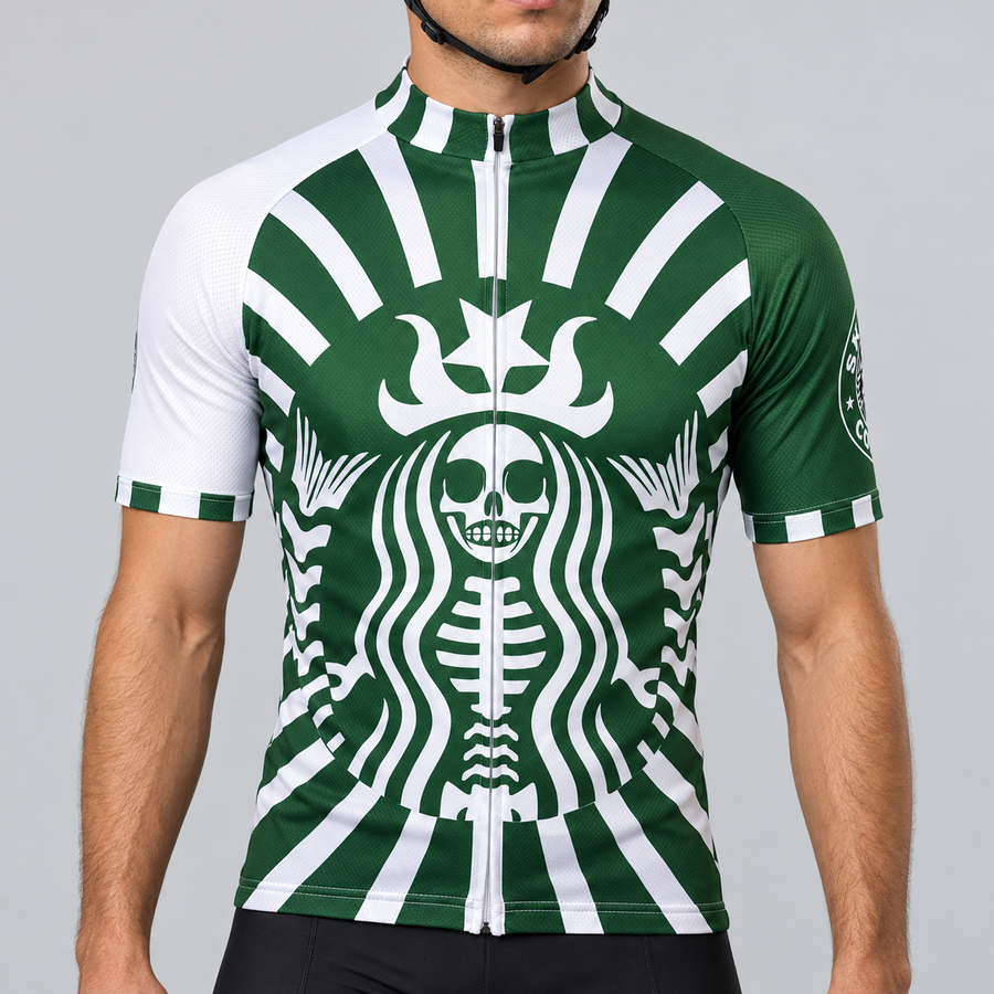 Male model shown from the chin down wearing the green and white Skeleton Coffee short-sleeve cycling jersey with a stylised crowned skeleton graphic against a light grey studio background.