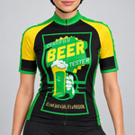 Female model wearing the black, green and yellow short-sleeve Certified Beer Tester cycling jersey with beer-glass graphic and black cycling shorts, shown from the lower lip and chin down against a light grey studio background.
